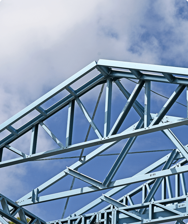 Steel trusses against a blue sky.