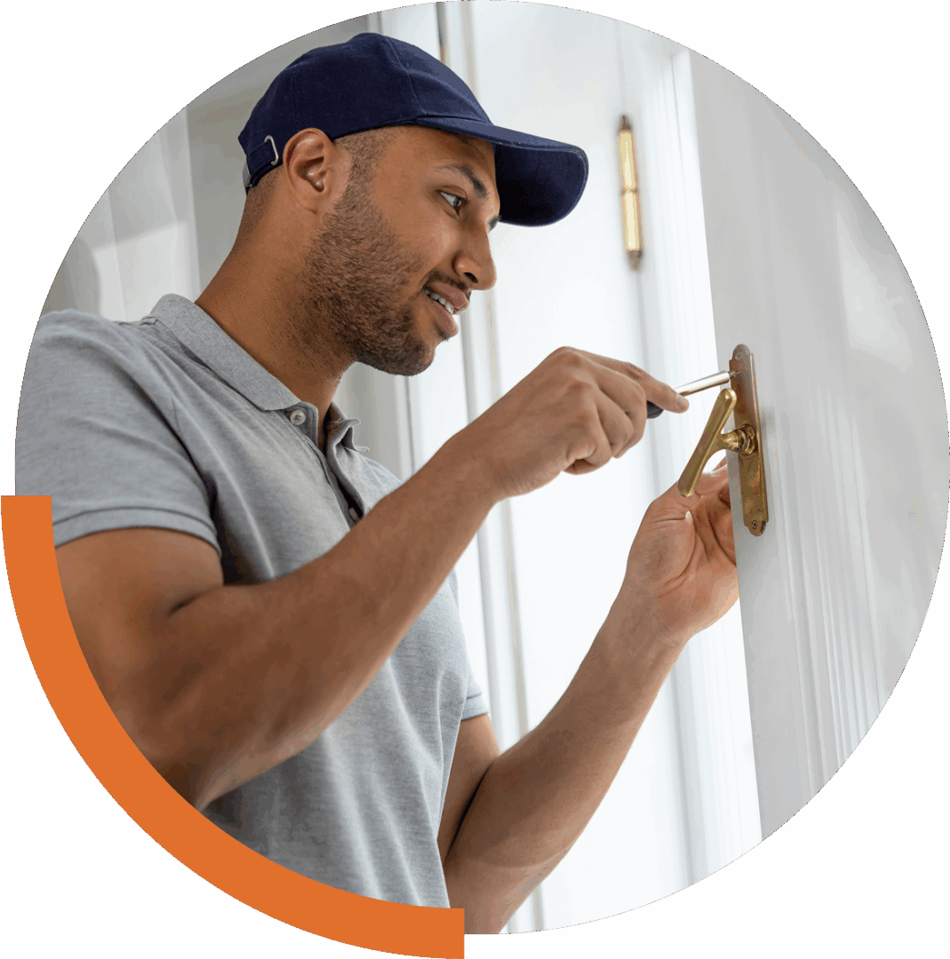 Man fixing door lock with screwdriver.